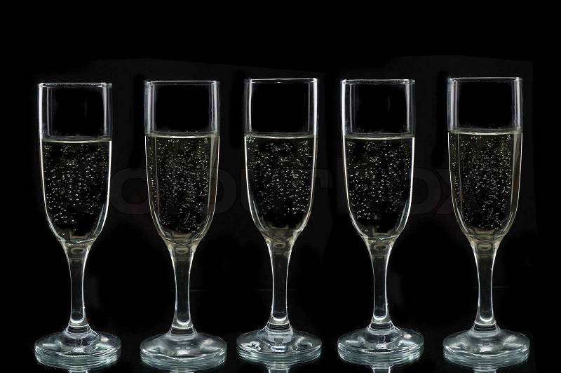 Champagne flutes against a black background, stock photo