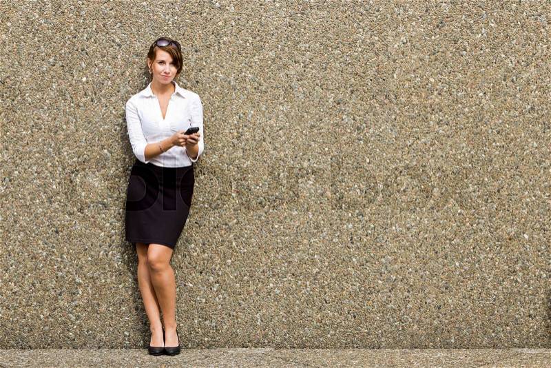 Young attractive business woman executive using her smart phone, stock photo