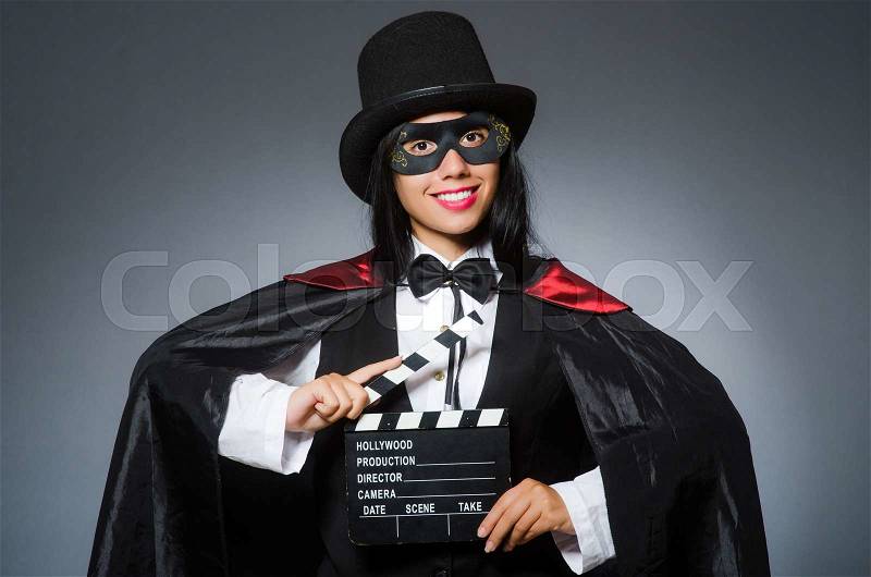 Woman wearing mask with movie board, stock photo