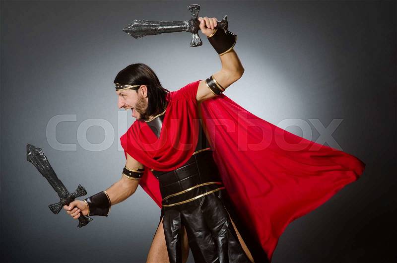 Roman warrior with sword against background, stock photo