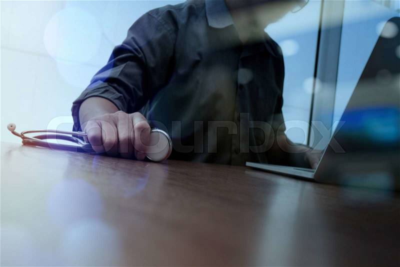 Doctor working with digital tablet and laptop computer in medical workspace office and medical network media diagram as concept , stock photo