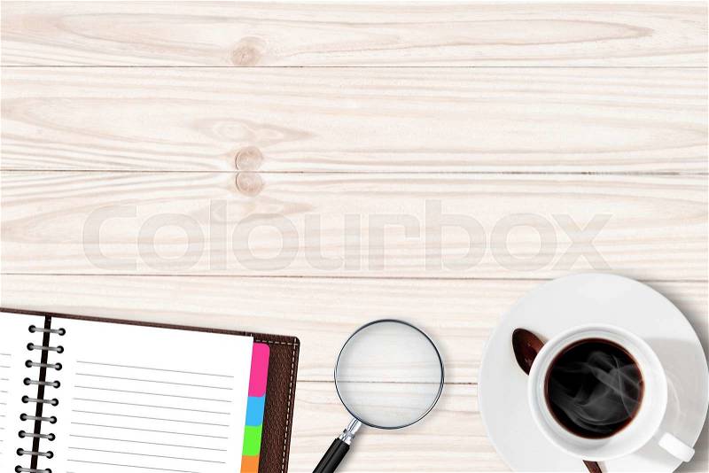 White table with coffee cup notebook Magnifying glass, stock photo