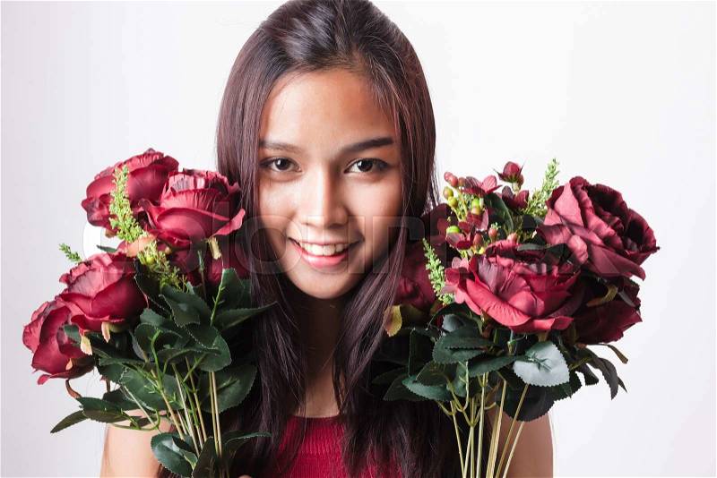 Closeup fashion portrait of asian young sexy woman posing in studio with red rose flower, stock photo