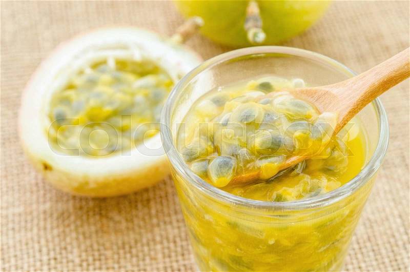 Passion fruit juice in glass and fresh passion fruit on sack background, stock photo