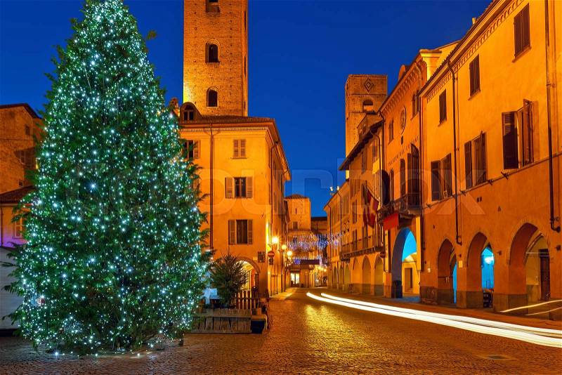 Illuminated Christmas tree on town square in Alba, Piedmont, Northern Italy, stock photo