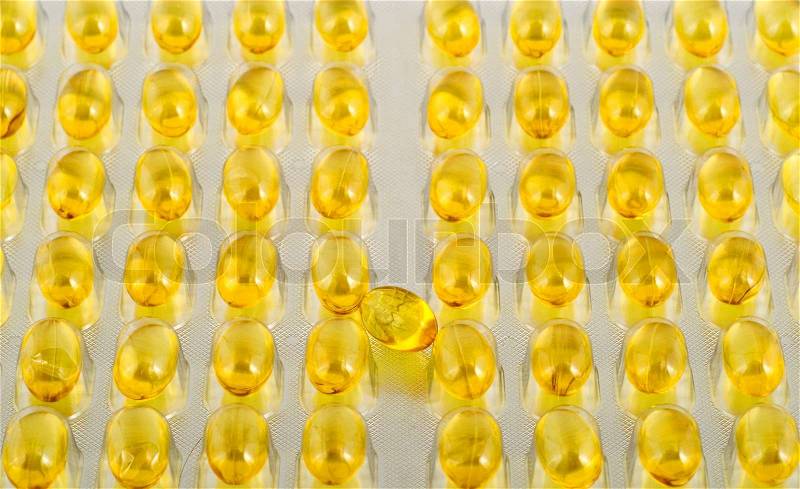 Fish oil capsule translucent on background of the capsules,close-up, stock photo