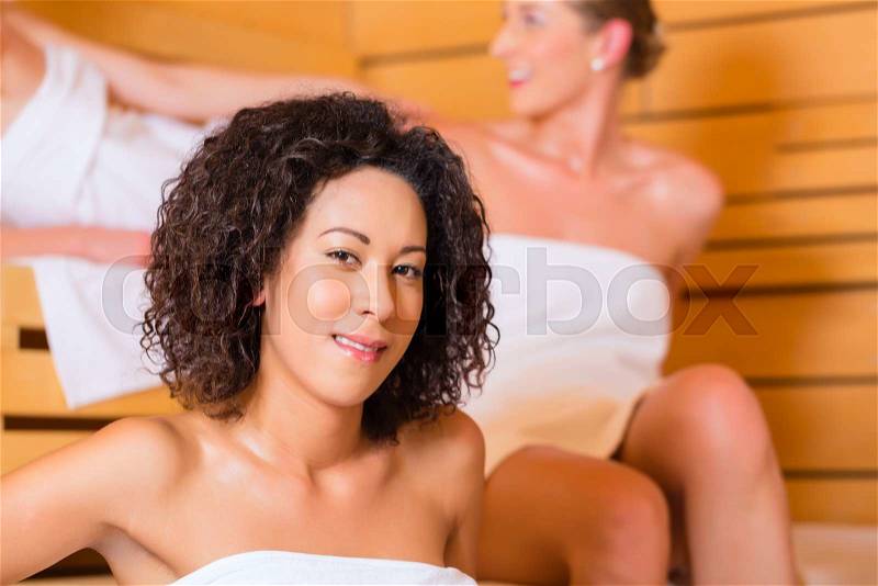 Woman enjoying wellness infusion in sauna, stock photo