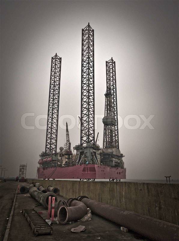 Oil rig close to Esbjerg harbour with pipes all over. Danish platform from North Sea, stock photo