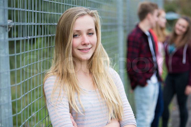 Portrait Of Teenage Girl Hanging Out With Friends In Playground, stock photo