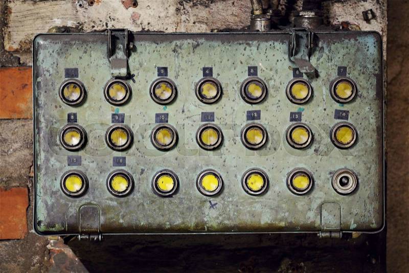 Old dirty electrical box with with push buttons in an old abandoned factory, stock photo
