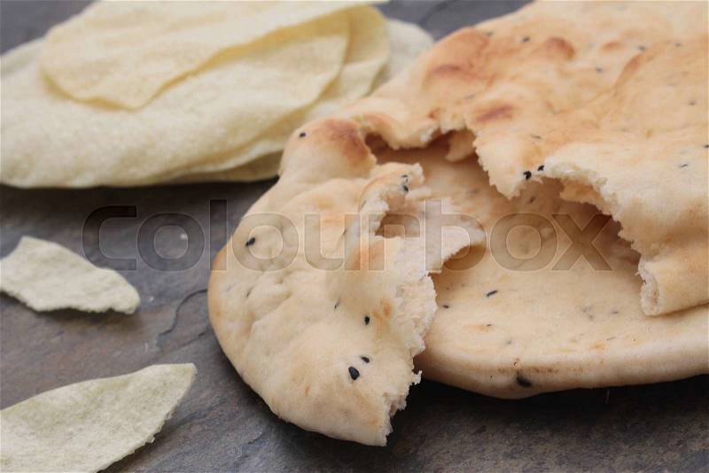 Indian naan bread and poppadum, stock photo