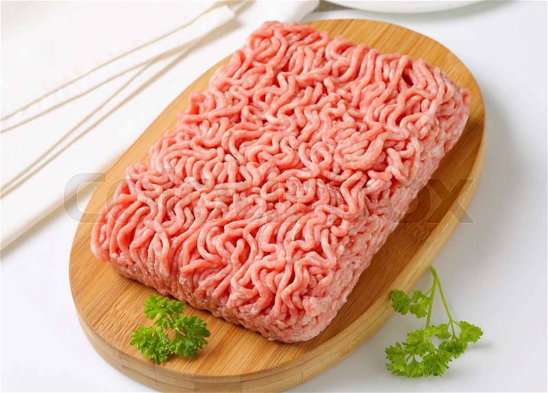 Raw ground pork on cutting board, stock photo