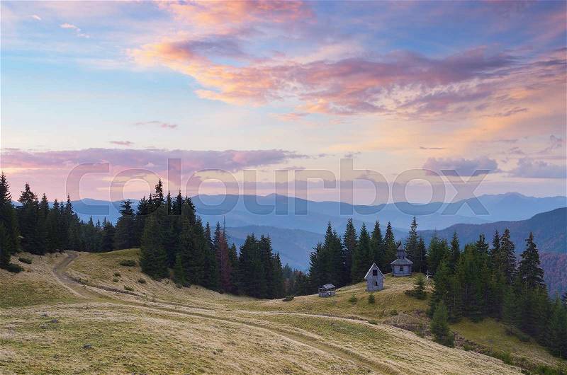 Autumn landscape. Old wooden church in the mountains. Colorful sunrise. Carpathians, Ukraine, Europe, stock photo