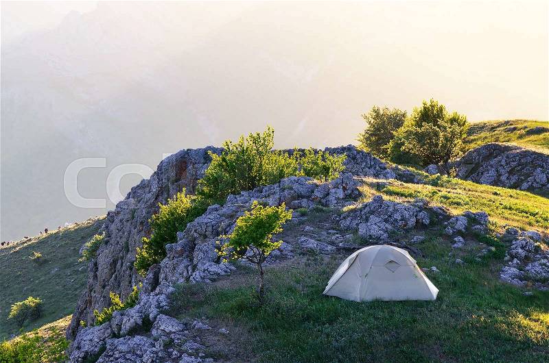 Spring landscape with tourist tent. Camping in the mountains of the Solar spring day, stock photo