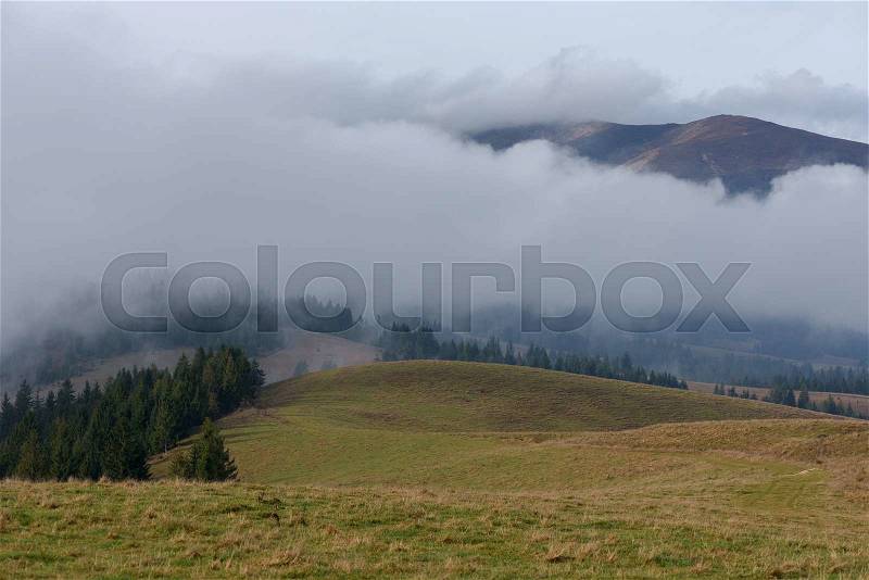 Autumn landscape. Low clouds in the mountains. Beauty in nature, stock photo
