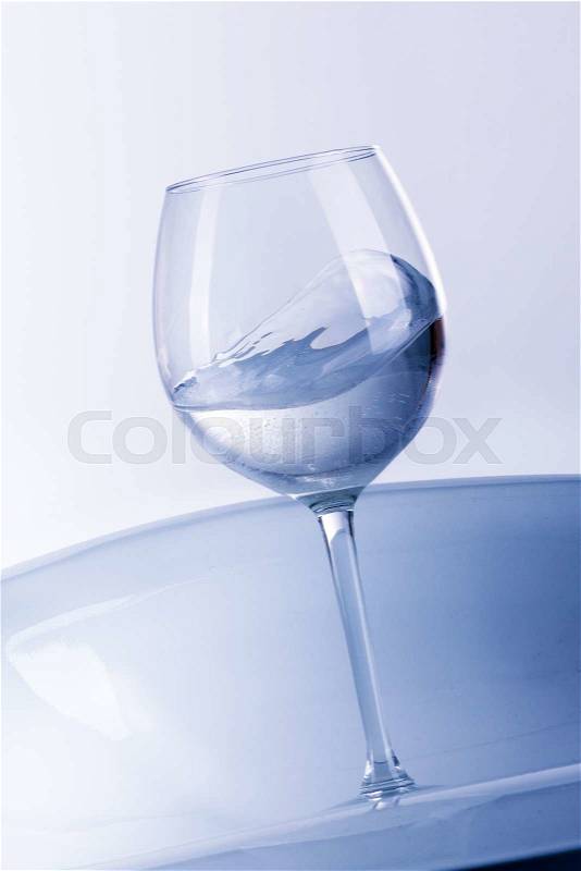Water splashing from glass isolated on white background, stock photo