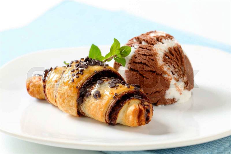 Chocolate chip croissant and scoop of vanilla chocolate ice cream, stock photo