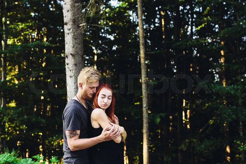 Guy hugging his girlfriend from the back, stock photo