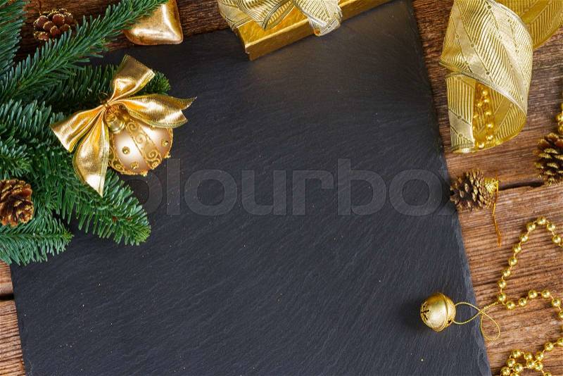 Evergreen tree with golden decorations christmas frame on black background, stock photo