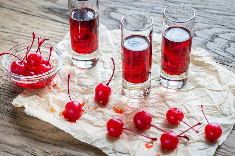 Glasses of cherry brandy with cocktail cherries, stock photo