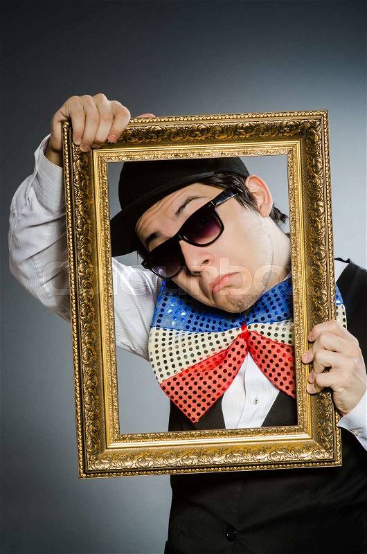 The funny man with picture frame, stock photo