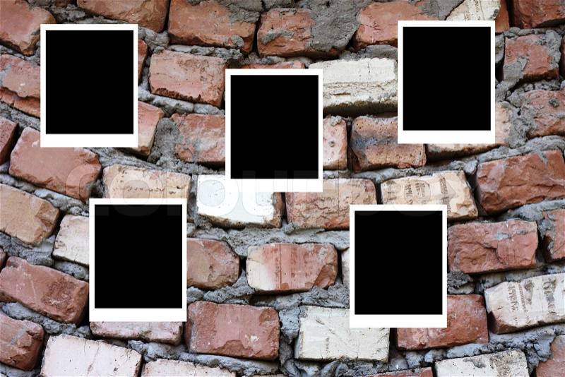 Set of five old blank polaroids frames lying on a brick surface, stock photo