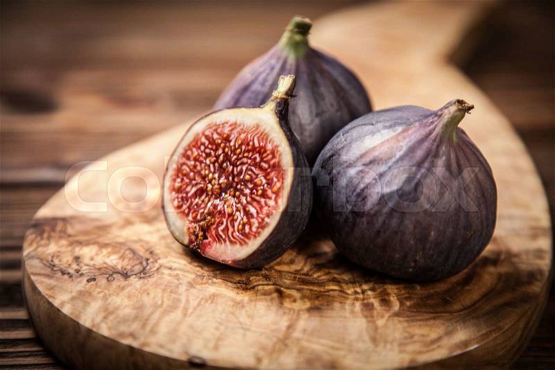 Delicious fresh figs on a wooden board, stock photo