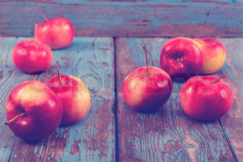 Fresh apples on painted blue wooden boards, stock photo