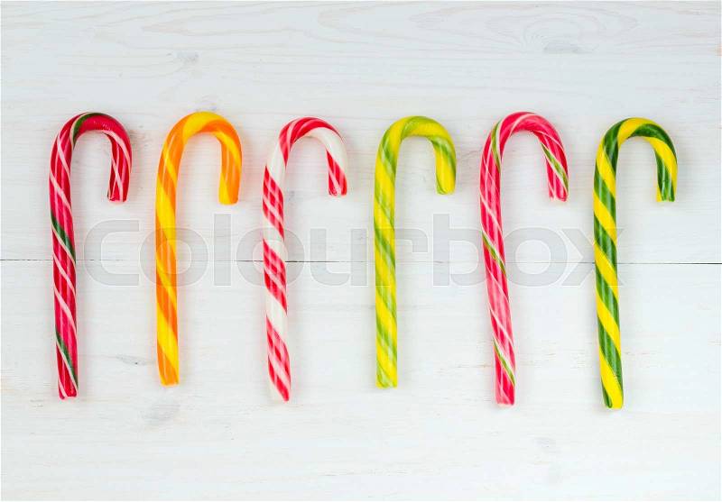 Christmas candy cane on the white wooden background, stock photo