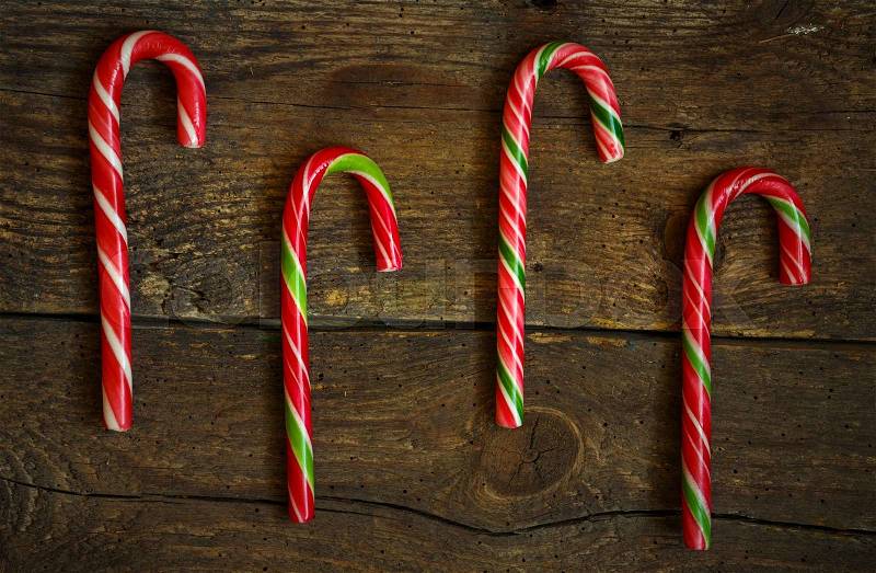 Candy canes on wooden boards - holidays background, stock photo