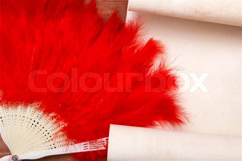 Decorative female fan of red feathers. Stylish accessories, stock photo