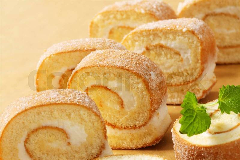 Slices of sponge cake roll with cream filling, stock photo