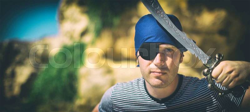 Male pirate with sword. Place for your text, stock photo