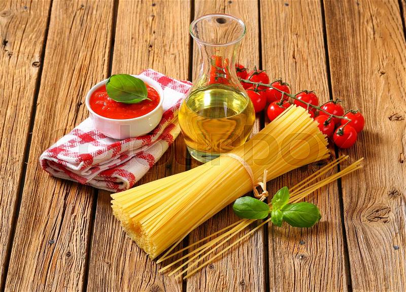 Still life of dried spaghetti, tomato puree and olive oil, stock photo