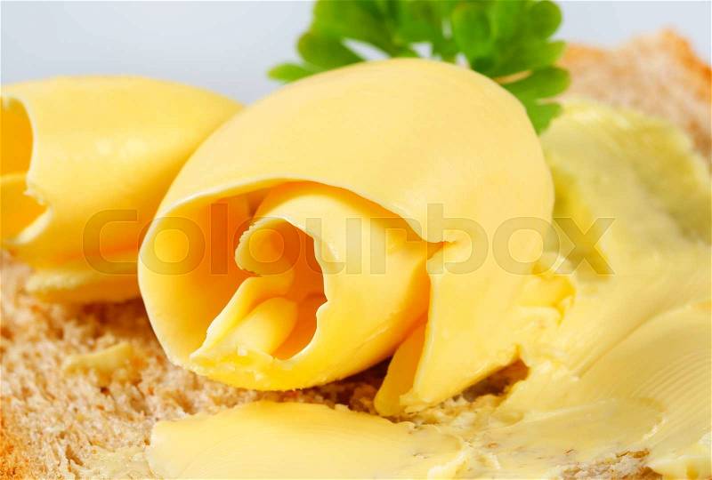 Fresh butter curls on bread, stock photo