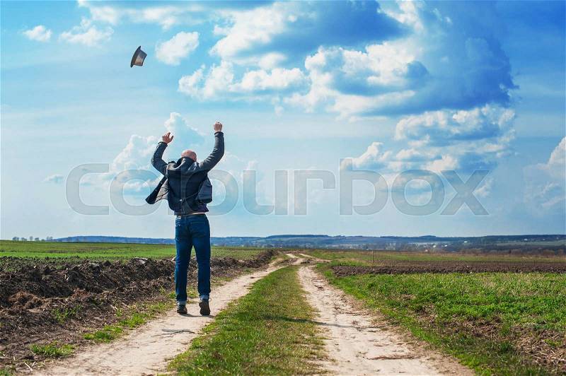 Man walks along a dirt road and enjoy the freedom, stock photo