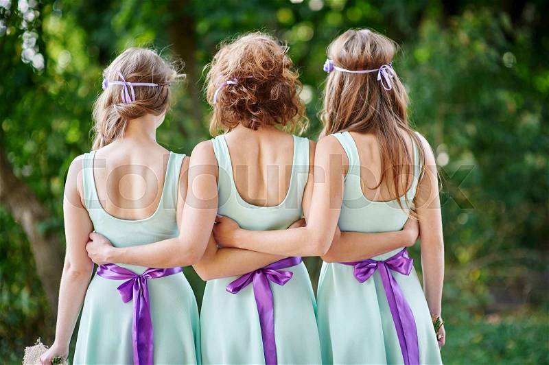Three bridesmaids are back in the park, stock photo