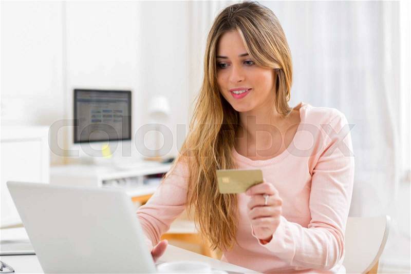 View of a Young attractive woman shopping online time at home, stock photo