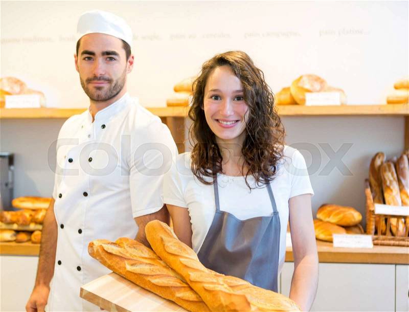 View of a Team of bakers working at the bakery, stock photo