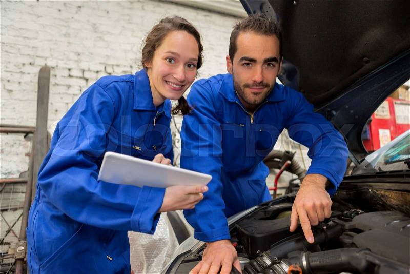 View of a Team of mechanics working at the garage, stock photo