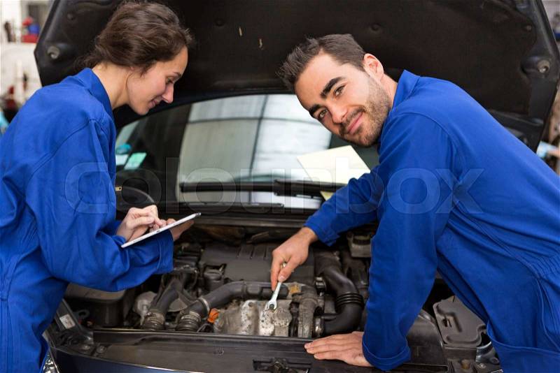 View of a Team of mechanics working at the garage, stock photo