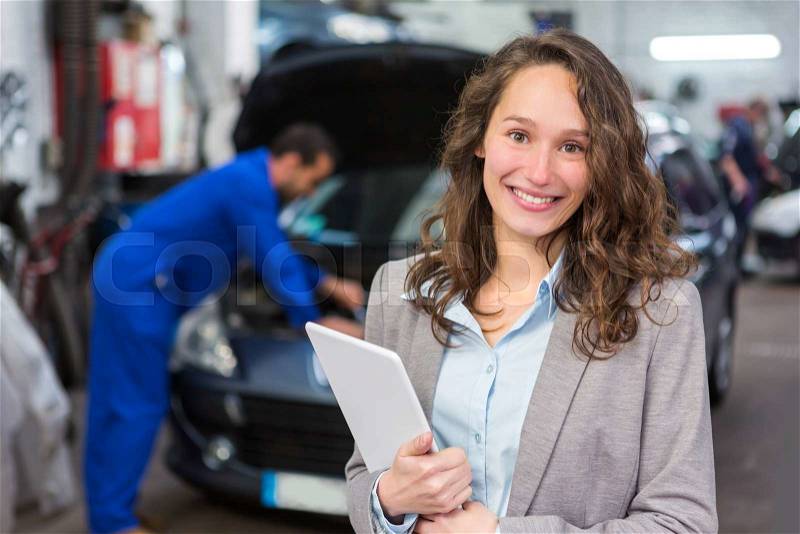 View of an Expert in autobile working in a garage, stock photo