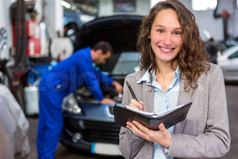 View of an Expert in autobile working in a garage, stock photo