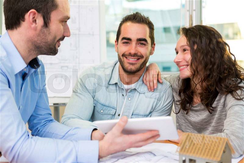 View of a Young attractive people meeting real estate agent at the office , stock photo
