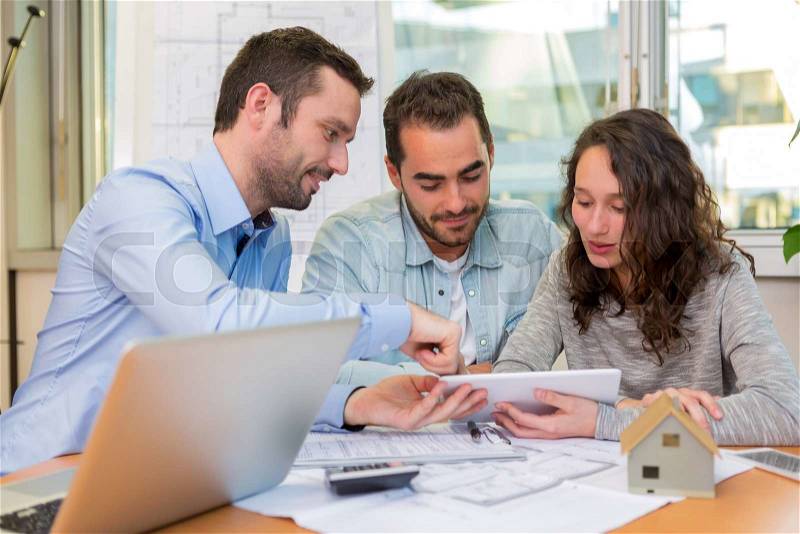 View of a Young attractive people meeting real estate agent at the office , stock photo