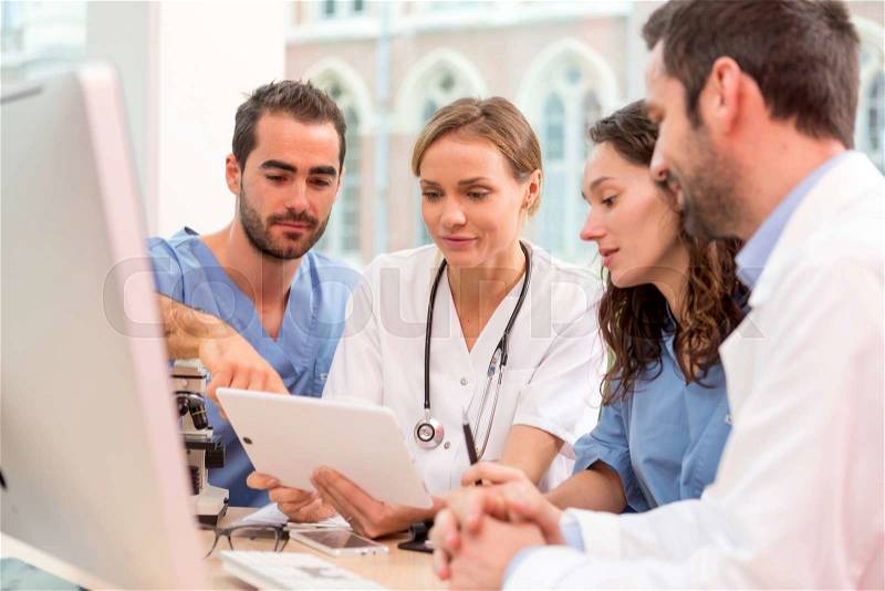 View of a Medical team working at the hospital all together, stock photo