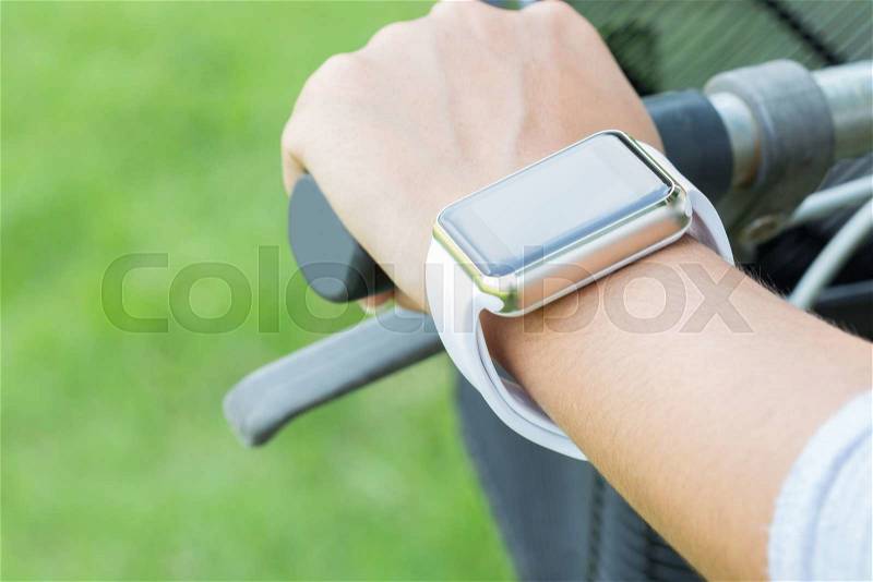 Closeup hand wear smart watch riding bicycle exercise sport, stock photo