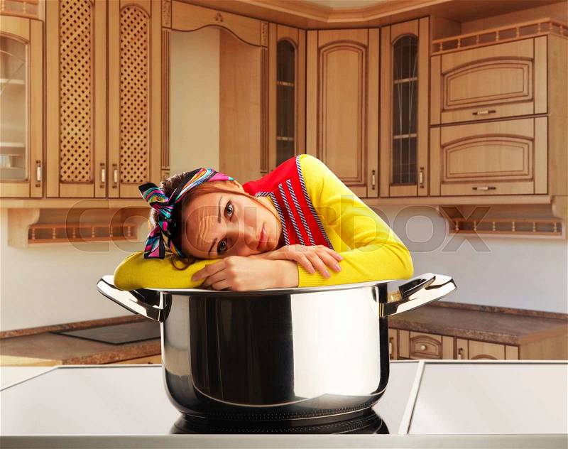 Sad housewife on the kitchen, stock photo