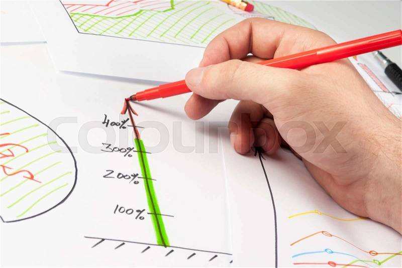 Man painting business diagram on white papers with soft-tip pen, stock photo