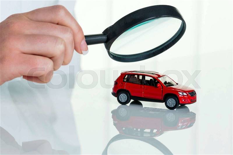 A model of a car is examined by a doctor. photo icon for workshop, service and car purchase, stock photo